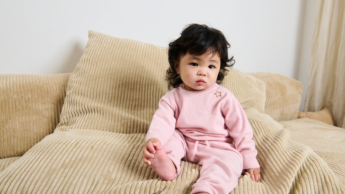 Girl in pink sitting on a couch