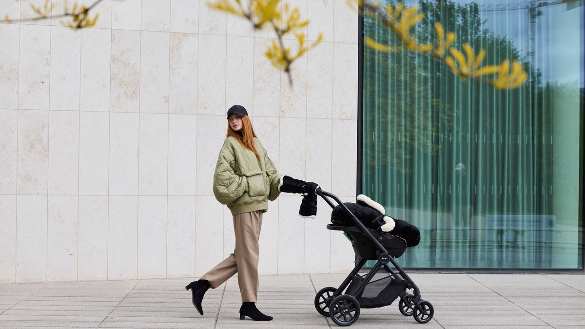 Woman walking with a stroller in an urban setting